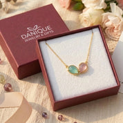Two birthstone necklace displayed in Danique Jewelry signature gift-ready packaging.