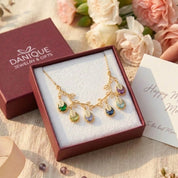 Personalized family tree birthstone necklace displayed in Danique Jewelry signature gift-ready packaging.
