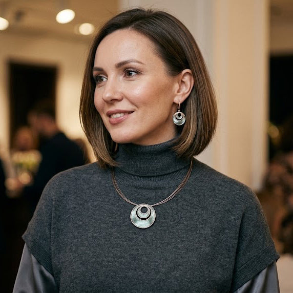 Woman wearing Sea Ice Layered Halo necklace and matching circular earrings
