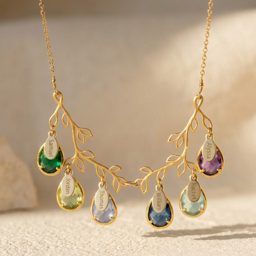 Gold family tree branch necklace with multiple colorful teardrop birthstones and personalized oval name tags.

