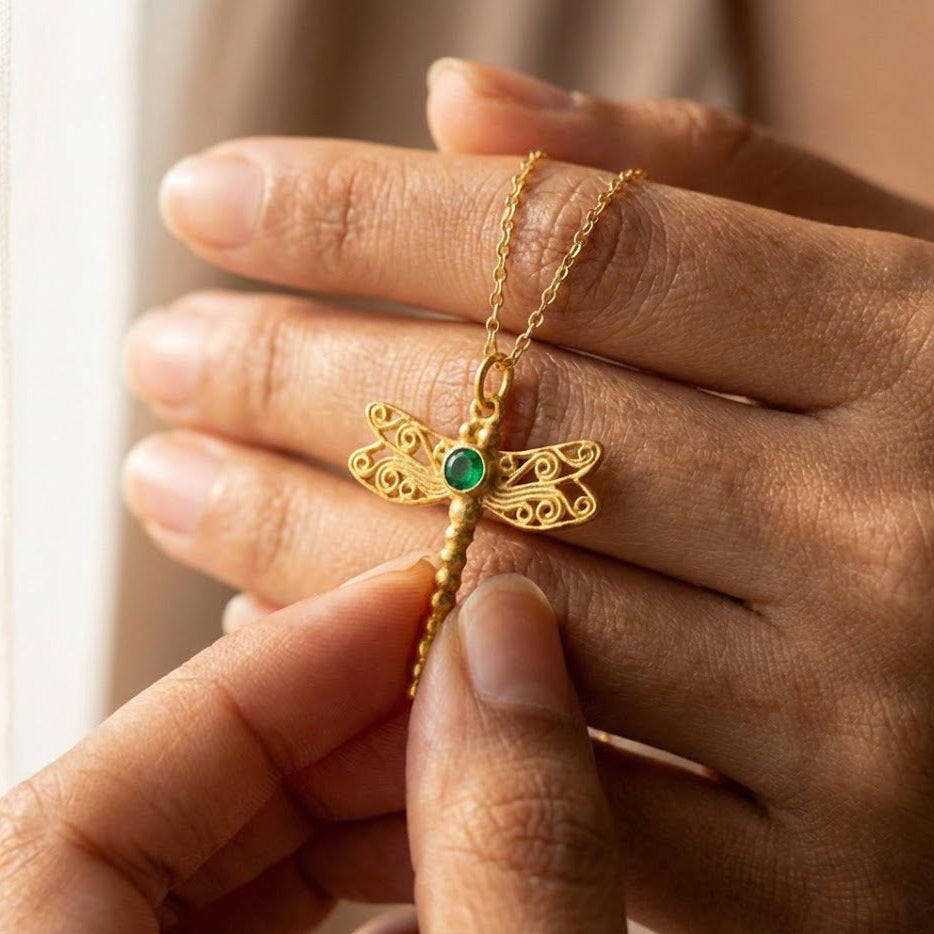 Hands holding gold dragonfly pendant necklace closeup, showing custom birthstone gemstone color choice and fine details, personalized dragonfly birthstone necklace in sterling silver or gold vermeil, meaningful gift for her, nature lover jewelry, sympathy memorial or remembrance necklace