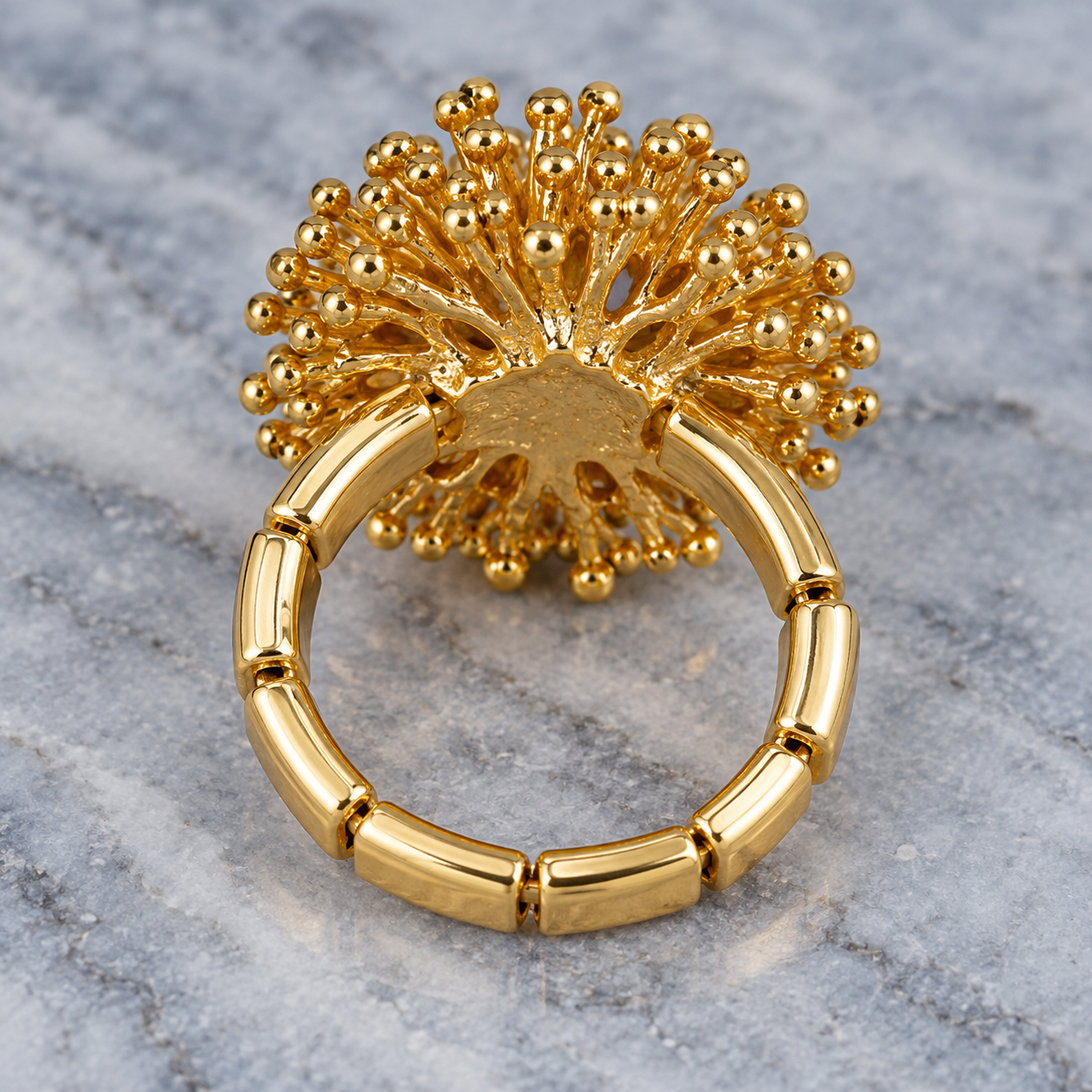 Side and back view of Gold Dandelion Puff adjustable ring showing flexible segmented band

