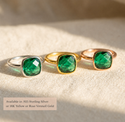 Three emerald quartz cushion rings shown in sterling silver, yellow gold, and rose gold finishes with text overlay for metal options.