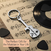 Guitar bottle opener keychain shown on sheet music with gift message. Personalized music gift for guitar players and musicians.