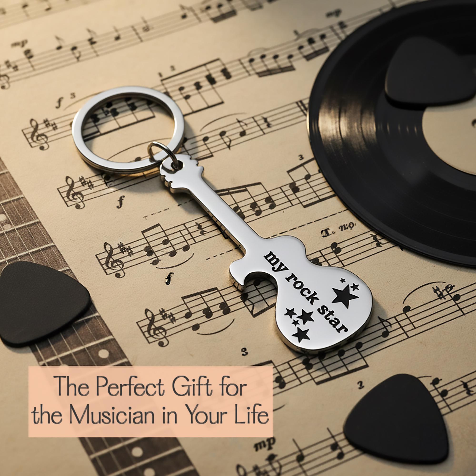 Guitar bottle opener keychain shown on sheet music with gift message. Personalized music gift for guitar players and musicians.
