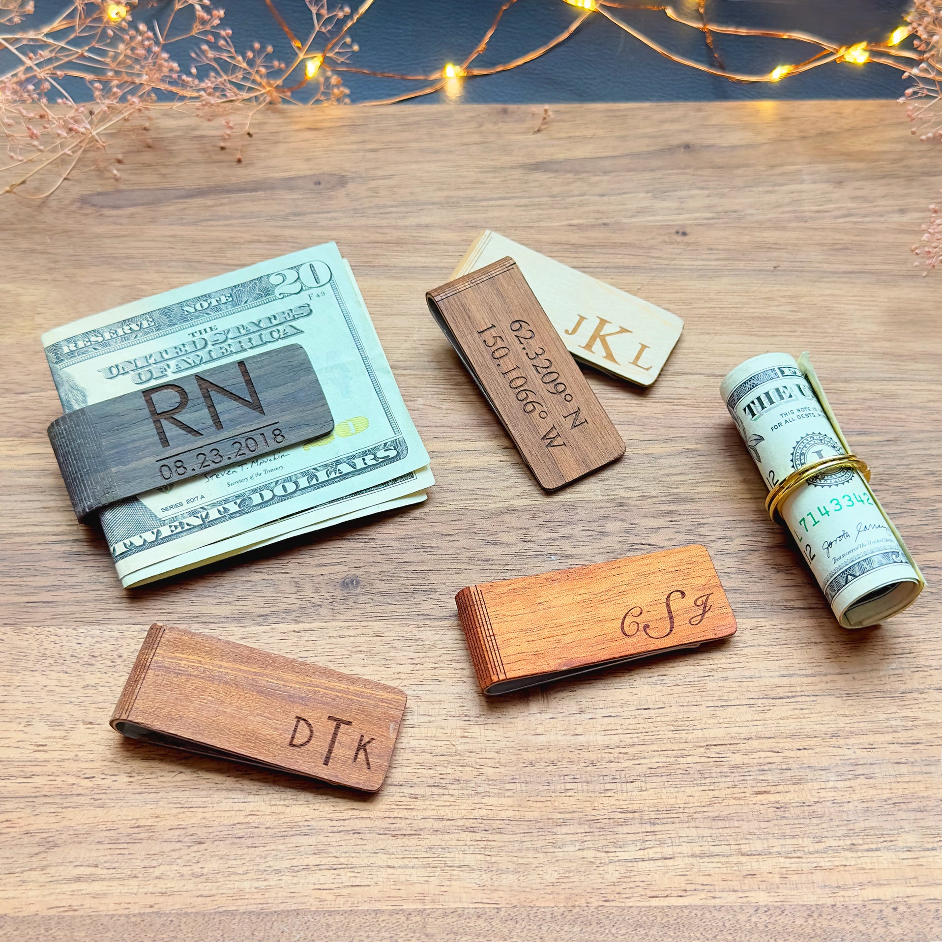 Personalized wood money clips in walnut, cherry, and maple, engraved with monograms, dates, coordinates, and initials. Handcrafted from solid wood with a stainless steel core for durability, these engraved wooden money clips are a stylish, minimalist alternative to bulky wallets. Ideal for weddings, groomsmen gifts, Father’s Day, graduations, anniversaries, and other special occasions, each piece is made to order in the USA and arrives gift-ready.