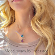Neck view displaying the blue-and-yellow teardrop lariat pendant centered on the chest, emphasizing dainty scale and elegant fall of the drops. Ideal as a subtle solidarity statement and everyday support-Ukraine necklace that pairs well with other chains. Keywords: ukraine pendant necklace, dainty layered necklace, women’s minimalist jewelry, peace for ukraine jewelry, blue and yellow necklace.