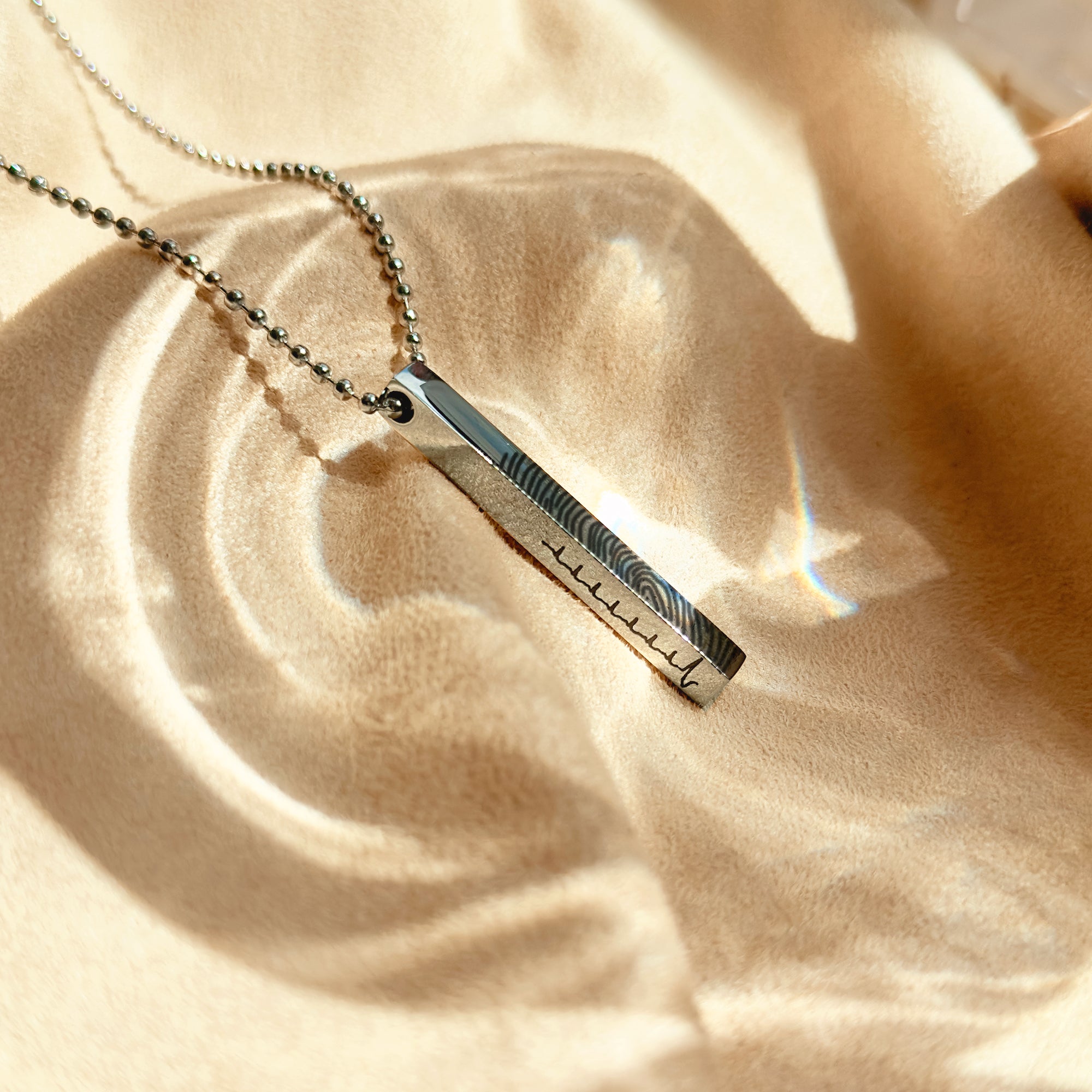 Men’s gold 3D bar necklace being held in hand, highlighting personalized engraving on multiple sides including coordinates, initials or Roman numerals. Modern minimalist vertical bar pendant for men, ideal custom jewelry gift for boyfriend, fiancé or dad for anniversary, Valentine’s Day or Father’s Day.