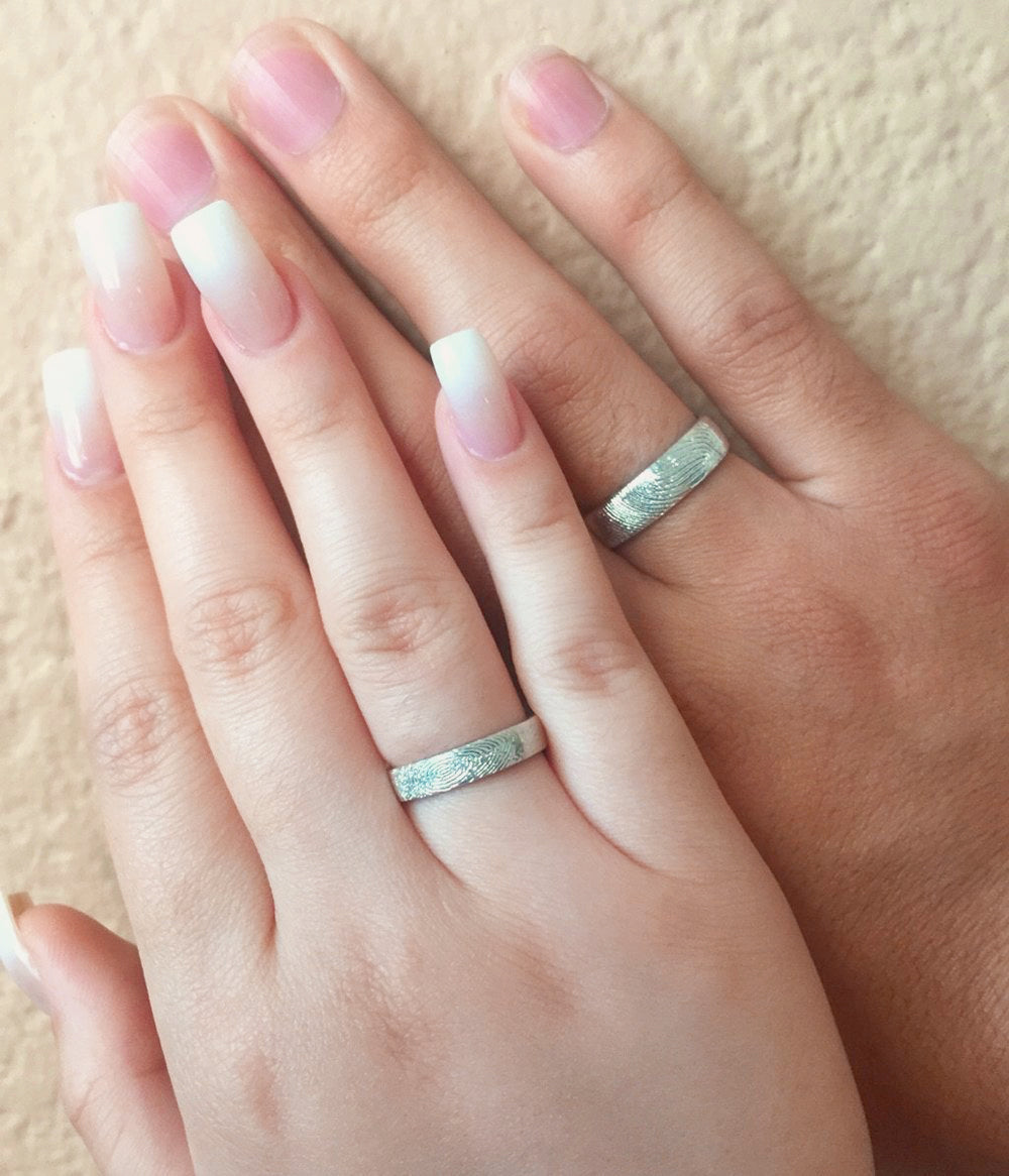 Couples displaying silver 4mm and 6mm rings. Gift for her, gift for him, memorial gift, commemorative gift, gift for fiance, gift for husband, gift for wife, gift for girlfriend, gift for boyfriend, silver anniversary gift, wedding gift, graduation gift, gift giving ready, christmas gift, valentine's day gift, birthday gift, family reunion gift, funeral gift, gift for those who lost loved ones, unique gifts for men, unique gifts for women. sterling silver band, finger band