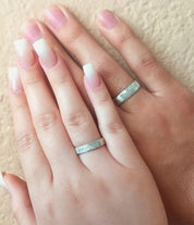 Couples displaying silver 4mm and 6mm rings. Gift for her, gift for him, memorial gift, commemorative gift, gift for fiance, gift for husband, gift for wife, gift for girlfriend, gift for boyfriend, silver anniversary gift, wedding gift, graduation gift, gift giving ready, christmas gift, valentine's day gift, birthday gift, family reunion gift, funeral gift, gift for those who lost loved ones, unique gifts for men, unique gifts for women. sterling silver band, finger band