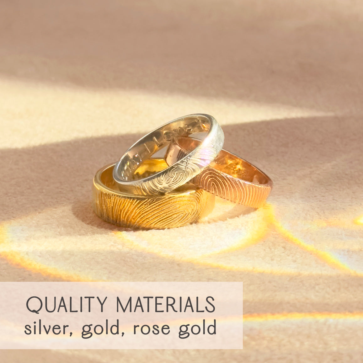 Three fingerprint engraved rings in sterling silver, yellow gold, and rose gold shown together, highlighting premium quality materials and craftsmanship. Unique custom bands designed as unisex fingerprint wedding rings, promise rings, or memorial keepsakes for couples and families. Each ring is engraved with detailed fingerprint impressions, creating meaningful personalized jewelry that honors love, memory, and connection. Perfect anniversary, sympathy, or engagement gift.