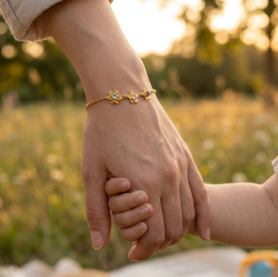 Mother and child holding hands wearing custom birthstone flower bracelet, meaningful mom bracelet gift