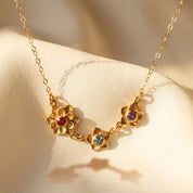 mother birthstone flower necklace with multiple small gemstone charms gold
