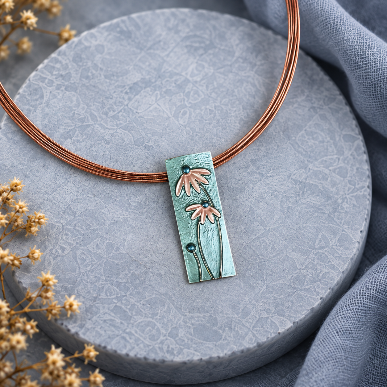 Bohemian rectangular flower necklace with sage green pendant on textured neutral background
