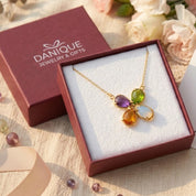 Four birthstone necklace displayed in Danique Jewelry signature gift-ready packaging.
