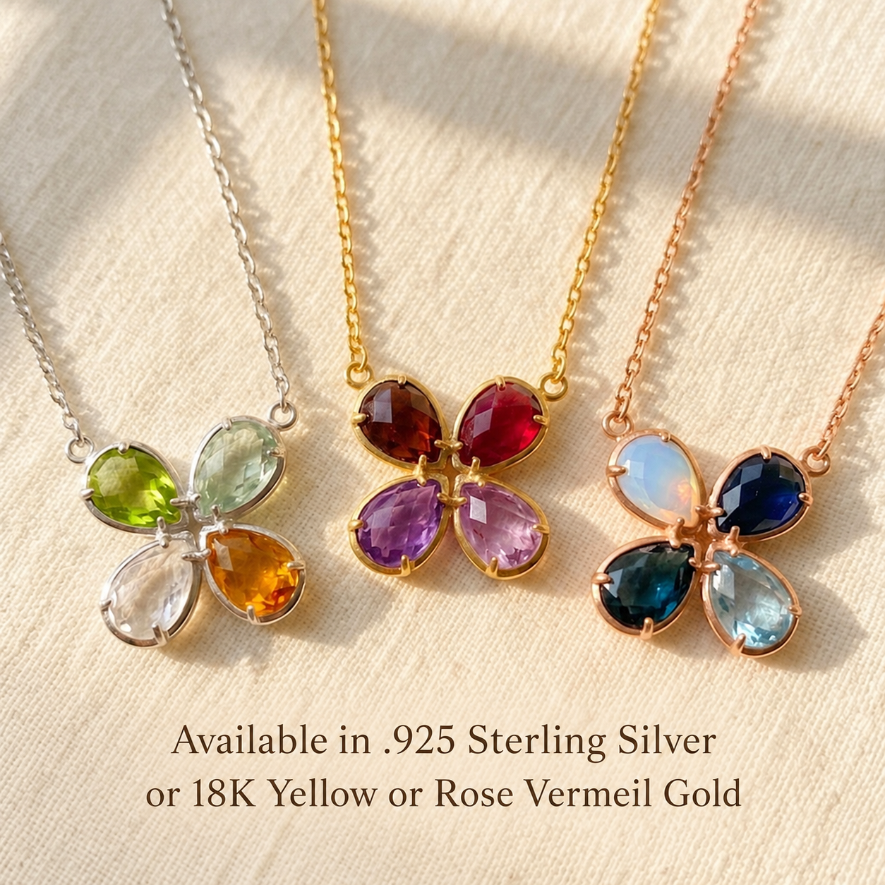 Custom birthstone necklaces shown in sterling silver, yellow gold and rose gold with colorful teardrop gemstones.
