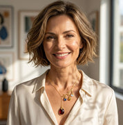 Custom family birthstone necklace with name engraved charms and large gemstone drop pendant in gold