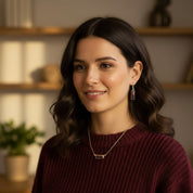 Garnet gemstone necklace styled with layered chains, showcasing minimalist baguette pendant and custom engraving, modern personalized jewelry for everyday wear