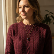 Woman wearing custom teardrop pendant January birthstone necklace in natural light