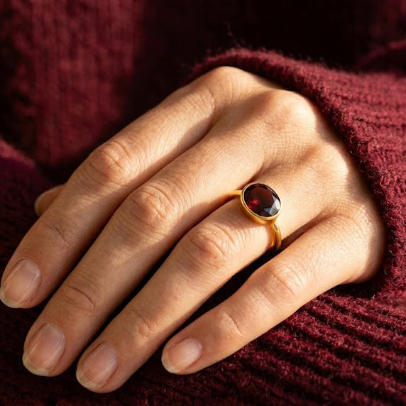 Sterling silver oval garnet ring, bezel setting with checker-faceted red gemstone; sleek minimalist January birthstone jewelry; durable 925 band for daily wear; stackable gemstone ring that pairs with gold vermeil and rose gold; meaningful birthday or graduation gift; handcrafted quality, nickel-free, comfortable fit.