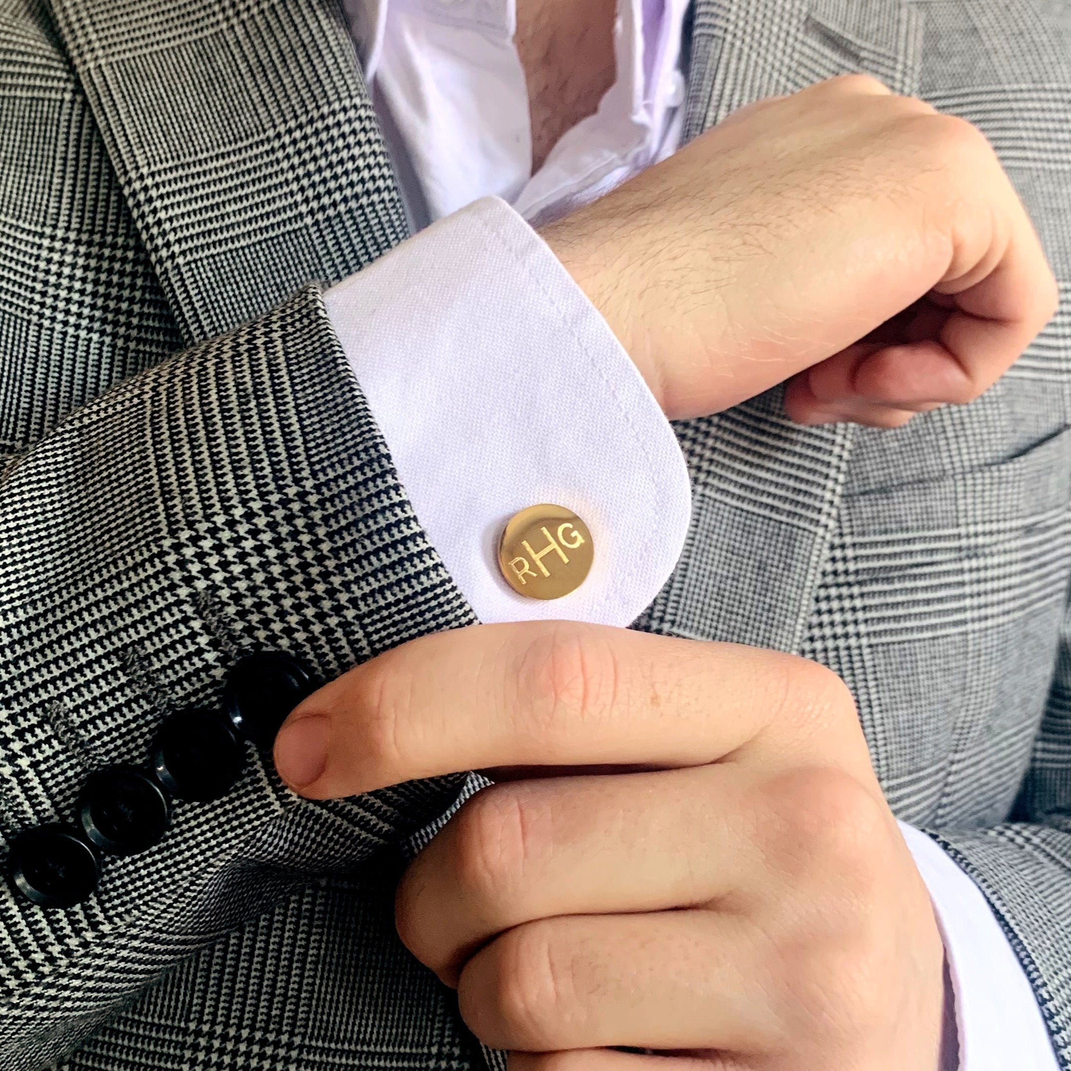 A man wearing a striped suit and gold monogrammed cufflinks. mens anniversary gifts, gifts for men, christmas gifts for him, valentine's day gifts for men, gift for husband, gift for fiance, father's day gift, birthday gift, wedding anniversary gift, wedding party gift, father of the groom gift, father of the bride gift, gift for grandfather, gift for grandpa, groomsman gift, groomsmen gift