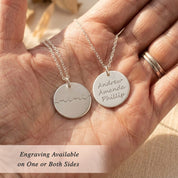 hand holding engraved disc necklace showing one side and both side engraving options for a custom grandma necklace