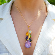 Woman wearing a grandmother birthstone necklace with cascading teardrop gemstones, symbolizing kids and grandkids. Handmade in sterling silver, gold vermeil, or oxidized silver, this personalized grandma jewelry makes a meaningful family keepsake. Perfect as a Mother’s Day necklace, Christmas gift for grandma, or push present for new moms. A sentimental piece of jewelry celebrating family connections and love.