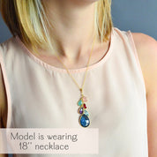 Model wearing an 18-inch teardrop pendant birthstone necklace in gold vermeil, featuring a cascading multistone design symbolizing children and grandchildren. This personalized grandmother jewelry gift showcases small, medium, and large gemstones representing family generations, creating a meaningful layered family birthstone necklace. A handmade keepsake and sentimental grandma gift, perfect for birthdays, Mother’s Day, or Christmas.