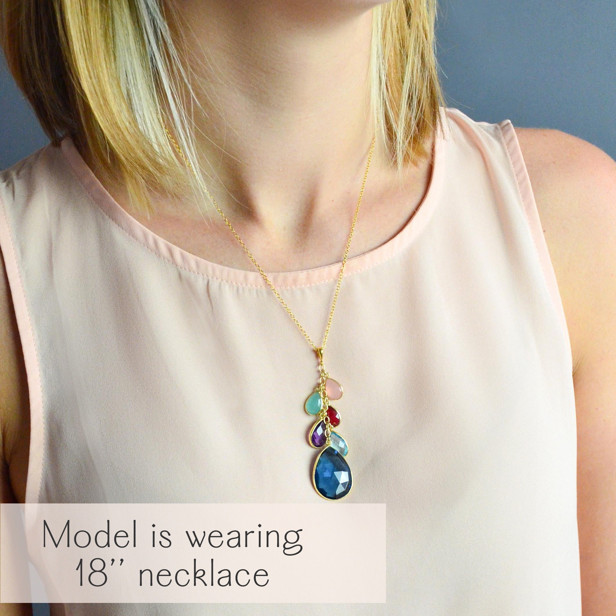 Model wearing an 18-inch teardrop pendant birthstone necklace in gold vermeil, featuring a cascading multistone design symbolizing children and grandchildren. This personalized grandmother jewelry gift showcases small, medium, and large gemstones representing family generations, creating a meaningful layered family birthstone necklace. A handmade keepsake and sentimental grandma gift, perfect for birthdays, Mother’s Day, or Christmas.