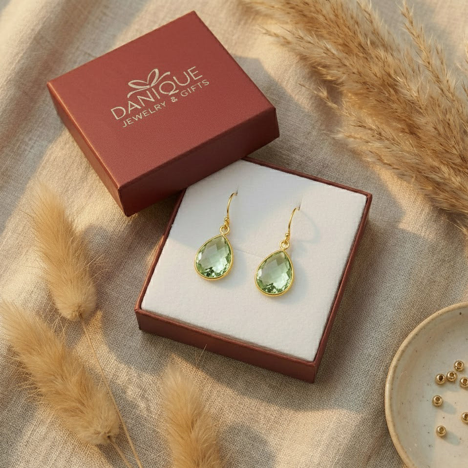 Green amethyst teardrop earrings displayed in Danique Jewelry gift box, faceted prasiolite gemstone earrings ready for gifting.