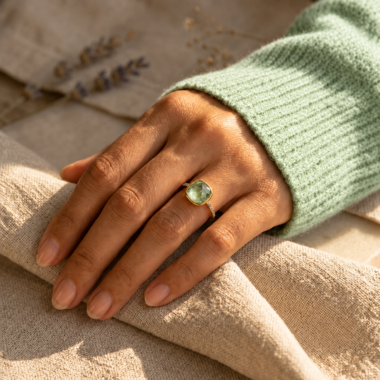 Green amethyst pave ring worn on hand in yellow gold
