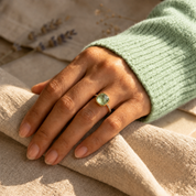 Green amethyst pave ring worn on hand in yellow gold
