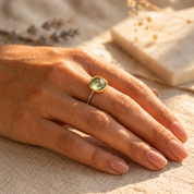 Woman wearing natural green amethyst pave ring
