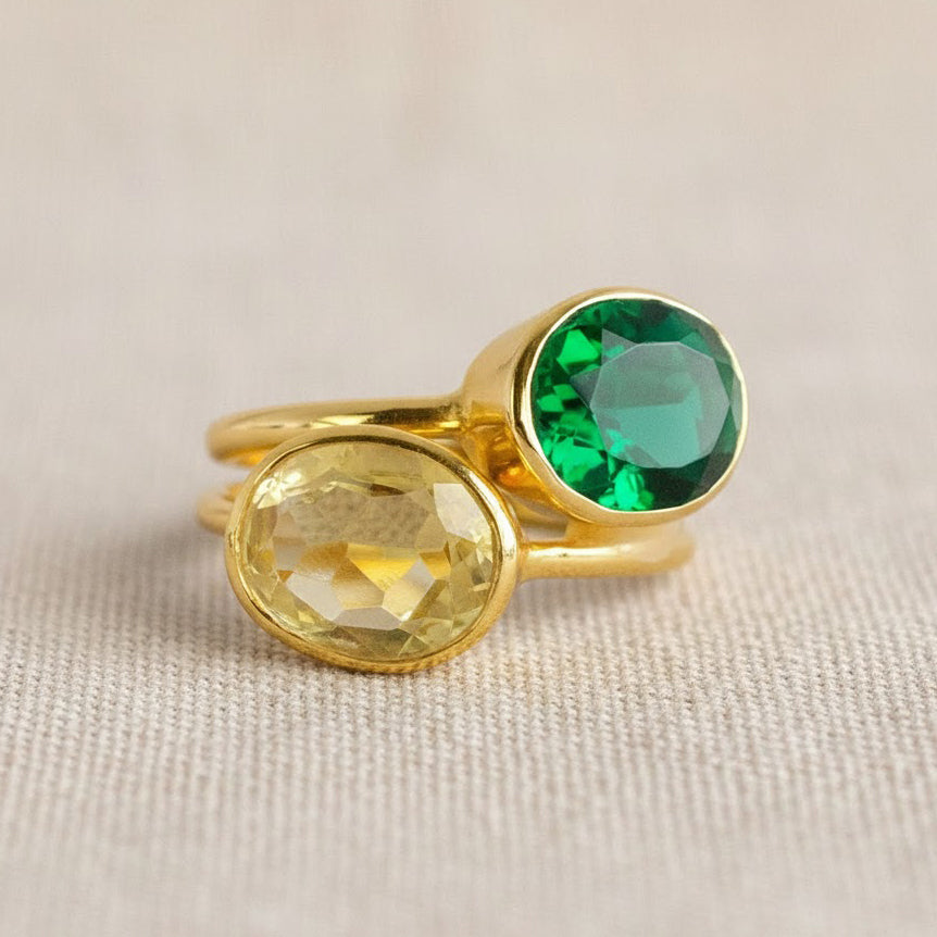 Close up of emerald quartz and citrine oval bezel setting, polished green gemstone ring with smooth gold vermeil finish
