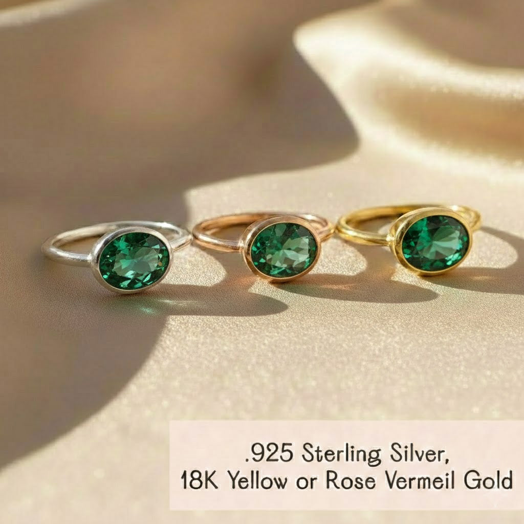 Three oval bezel gemstone rings styled together including emerald quartz May Birthstone ring in sterling silver, yellow or rose gold