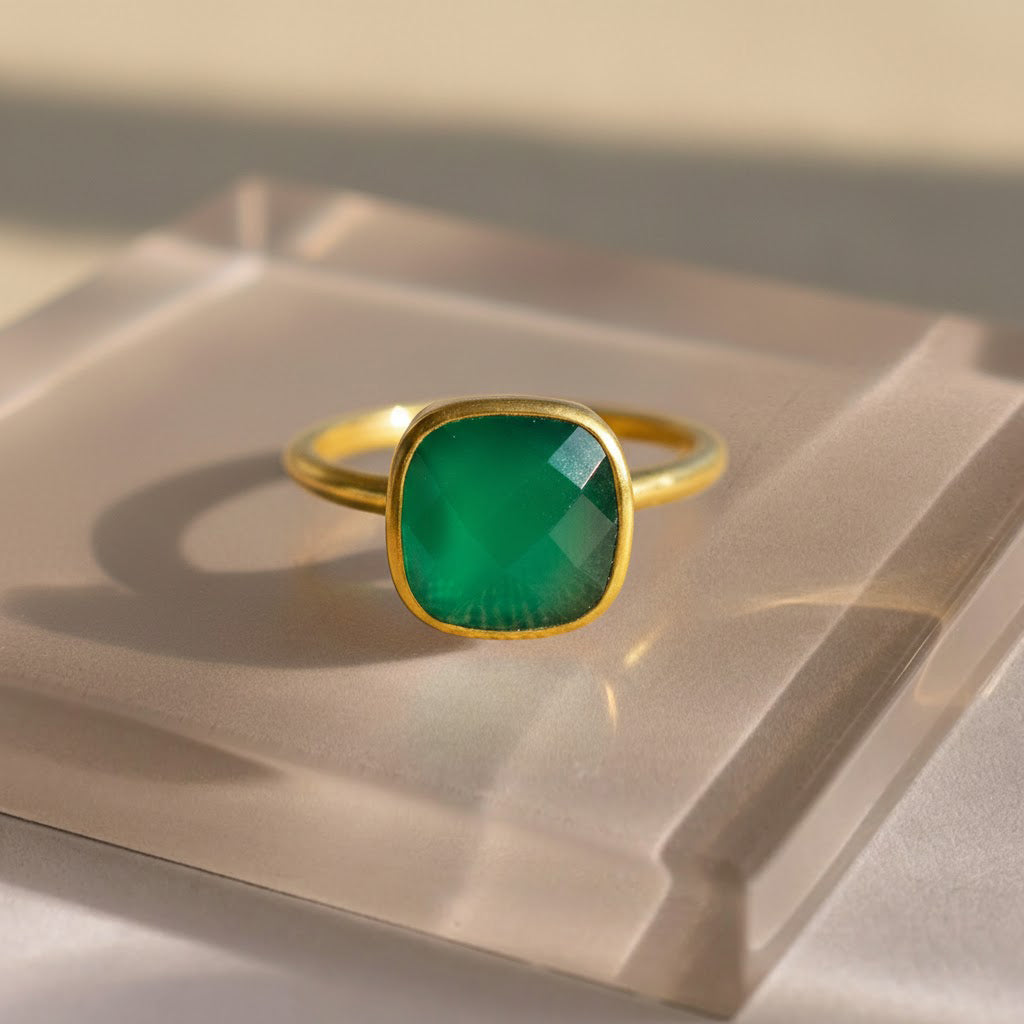Green onyx cushion cut bezel set ring displayed on neutral background, featuring a faceted green onyx gemstone in a smooth gold bezel. Minimalist May birthstone ring designed for everyday wear, stacking, or gifting, available in sterling silver or gold vermeil.