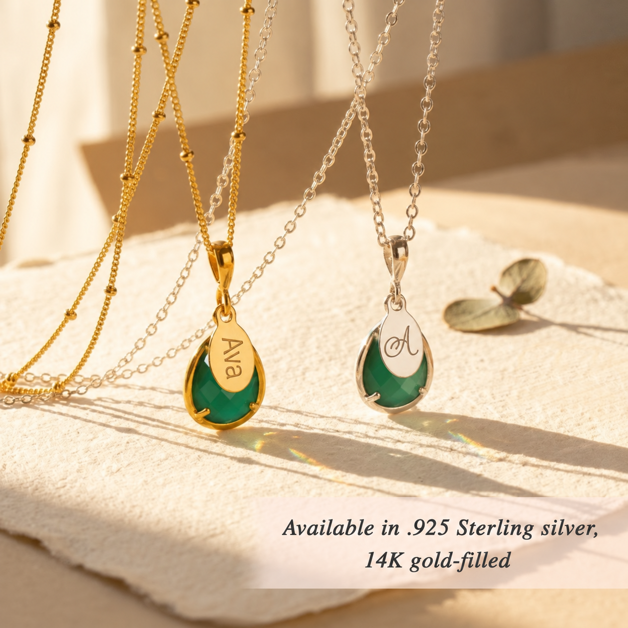 Personalized Green Onyx teardrop birthstone necklaces with engraved oval name charms in gold and sterling silver.
