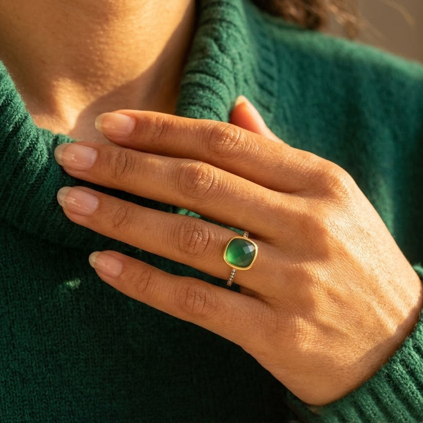 Woman wearing a gold-vermeil green onyx cushion ring with white quartz pavé accents.