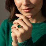 Woman wearing cushion cut green onyx gold ring, 9mm square emerald green gemstone in modern bezel setting, bold minimalist statement ring styled in natural light, elegant stacking gold gemstone ring for women, handcrafted fine jewelry, square green onyx ring gift for her, contemporary bezel set gemstone jewelry