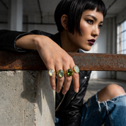 Stacked green tourmaline gemstone rings in gold setting styled for modern fashion look, bold October birthstone statement jewelry for women