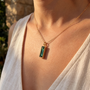 Woman wearing personalized green tourmaline vertical bar necklace
