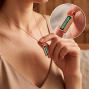 Close up of green tourmaline vertical bar necklace in yellow gold
