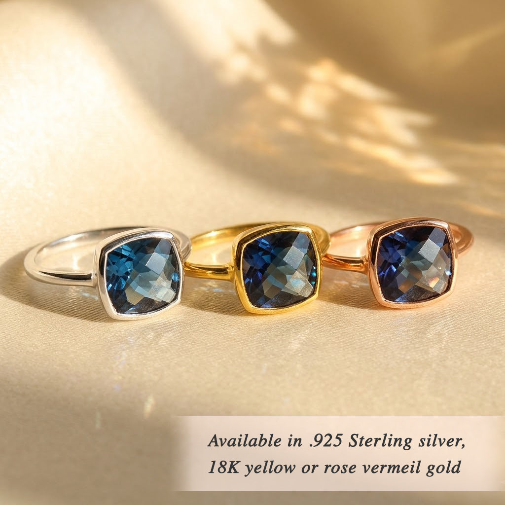 Kyanite ring held in hands showing faceted blue gemstone and bezel setting detail