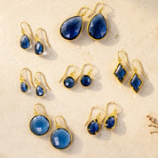 Blue kyanite earrings in gold with teardrop, round, oval, and geometric shapes, September birthstone earring collection for women
