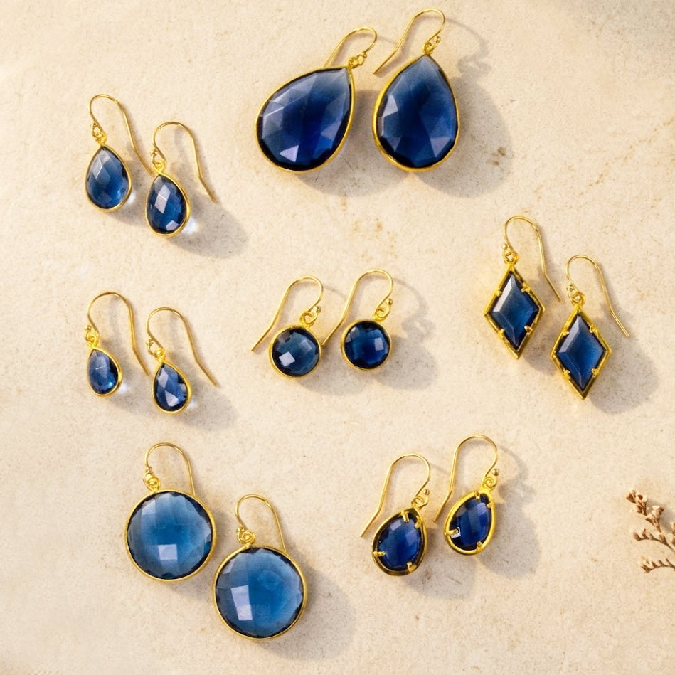 Blue kyanite earrings in gold with teardrop, round, oval, and geometric shapes, September birthstone earring collection for women