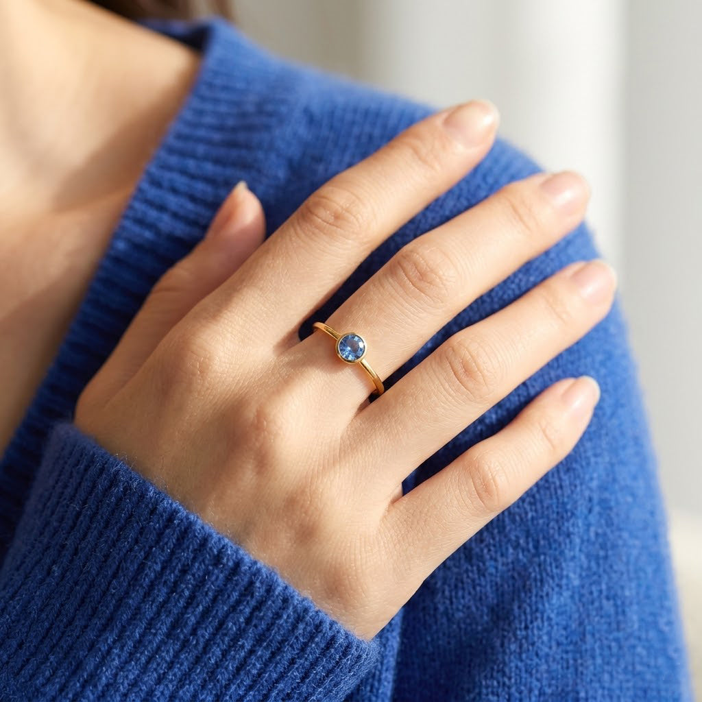 Model wearing dainty kyanite ring, sapphire blue September birthstone ring in gold vermeil