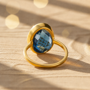 Large teardrop Kyanite ring in yellow gold vermeil displayed from the side in warm natural light.