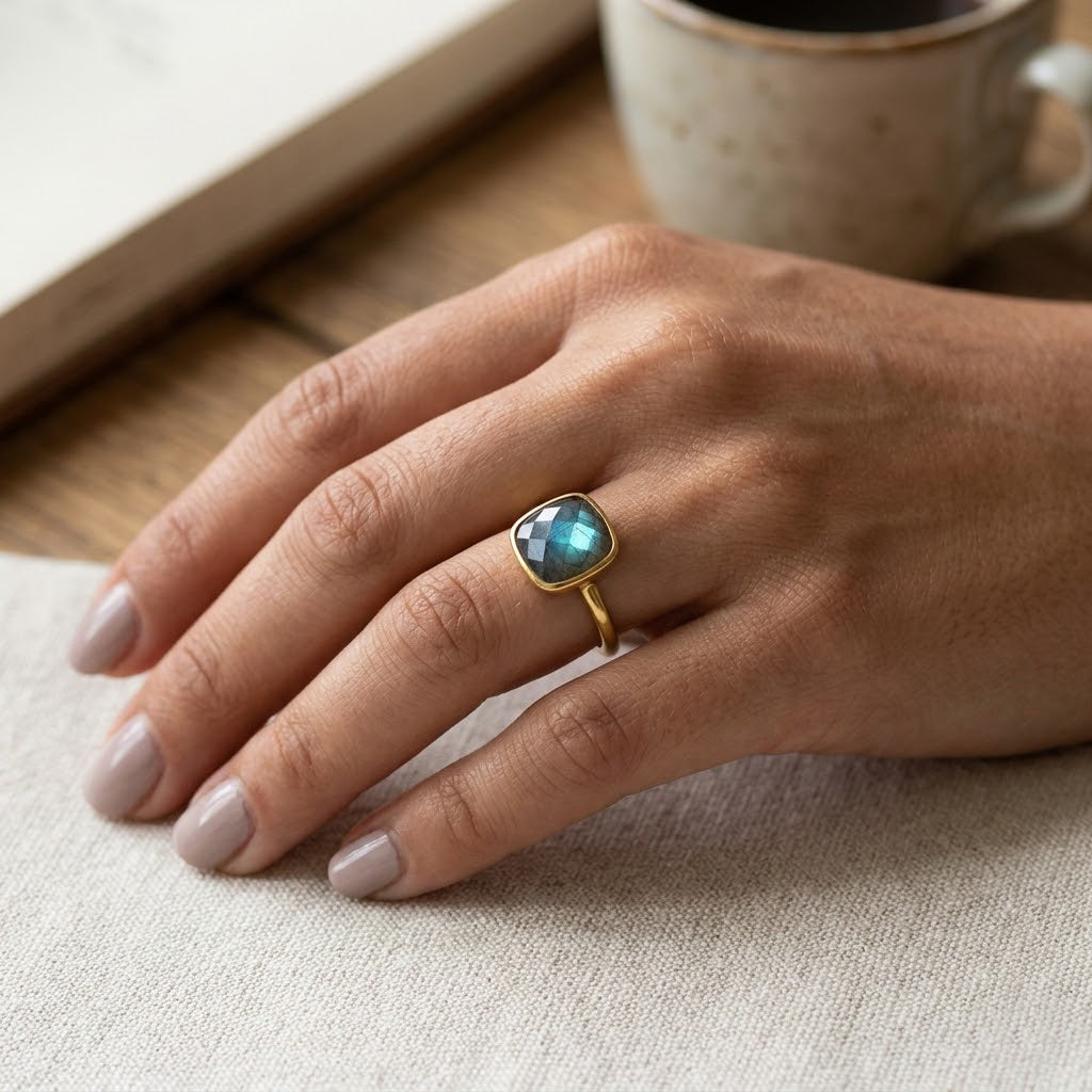 Minimalist labradorite ring worn on hand with soft neutral background aesthetic