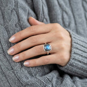 Labradorite statement ring worn on hand with gold band and glowing blue fire stone
