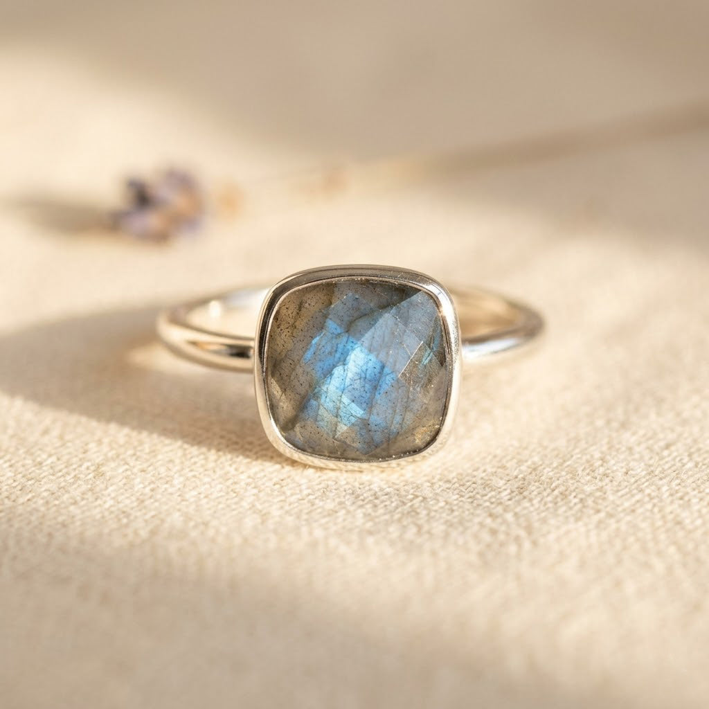 Minimalist labradorite ring worn on hand with soft neutral background aesthetic